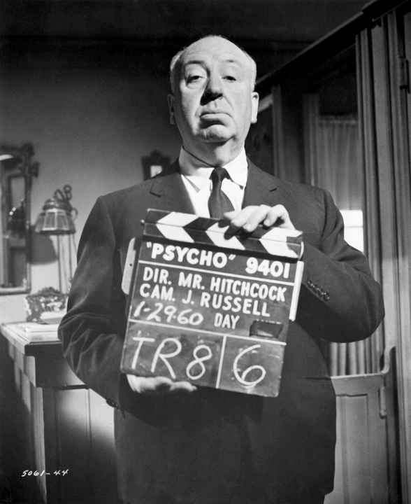 Alfred Hitchcock Holding Clapboard on Set