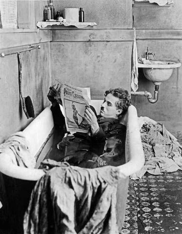 Charlie Chaplin Reading a Newspaper in Bathtub Reproduction Art Print